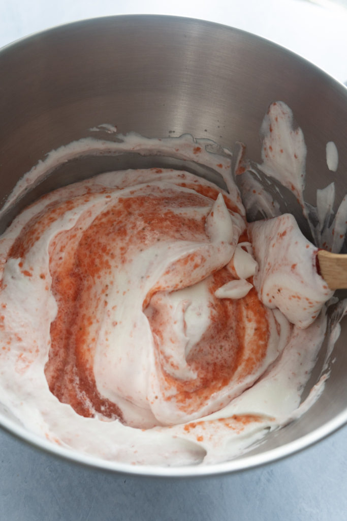 Strawberry sauce mixing with whipped cream